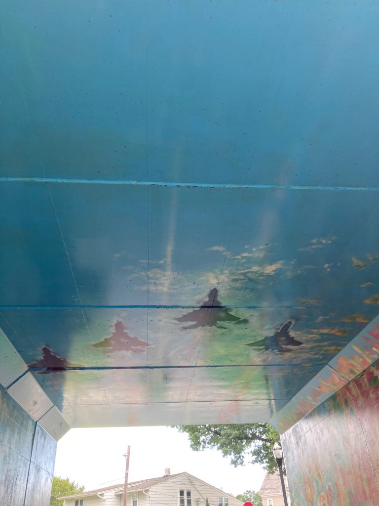 Mural on ceiling of tunnel, depicting fighter jets in flight