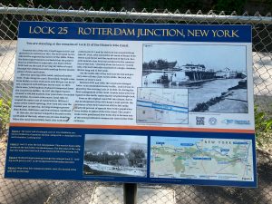 Close-up of sign reading "Lock 25 Rotterdam Junction, New York", which also has several paragraphs of information about the old lock, as well as a map and old photographs.